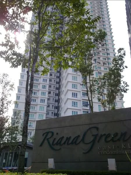 Exterior type: high-rise condominium; features: glass curtain wall, white painted facade, recessed balconies, mature trees, manicured landscaping, signage with name 'Riana Green', surrounded by greenery; style: modern.