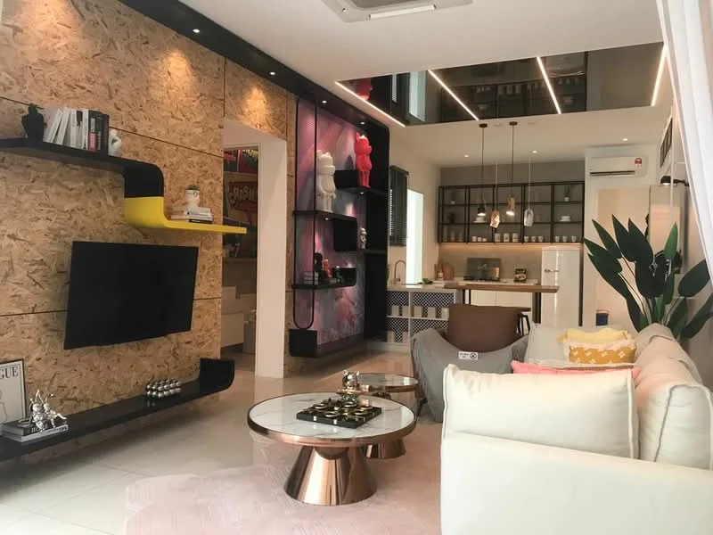 Living features: sofa in light grey fabric, coffee table with metallic base, area rug in light pink, wall-mounted TV, decorative shelving unit with black and yellow accents, exposed wood paneling on one wall, recessed LED downlights, large windows with natural light, decorative plants, artwork on the wall, open layout to kitchen, ceiling with integrated lighting; style: modern. Kitchen features: kitchen island with seating, black cabinetry, white countertops, built-in appliances, open shelving, backsplash with patterned tiles, recessed lighting, window for natural light; style: modern.