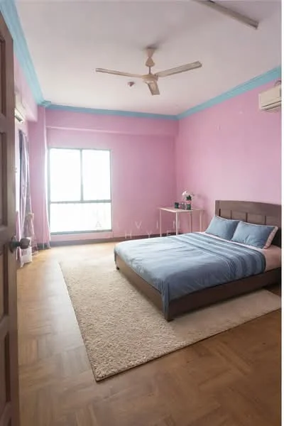 Bedroom features: pink painted walls, wooden flooring, 5-blade ceiling fan, floor-to-ceiling window, sheer curtains, queen-size bed with upholstered headboard, blue bedding, area rug, side table, decorative plant; style: modern.
