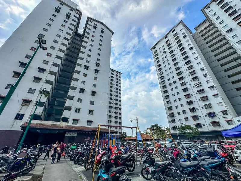 Exterior type: high-rise condominium; features: two high-rise buildings, balconies on each floor, multiple windows on each floor, parking area with motorcycles, children's playground, open space in front of buildings, surrounding greenery, cloudy sky, street lighting, entrance area with awning; style: modern.