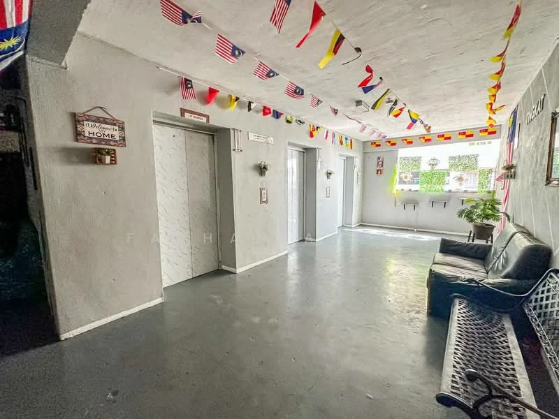 Room features: grey painted walls, concrete flooring, elevator access, decorative flags hanging from ceiling, potted plant, bench seating, wall-mounted light fixtures, window with natural light.