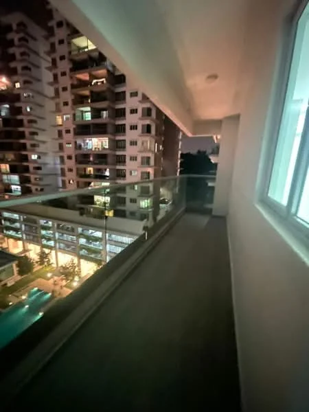 Room features: glass railing, concrete flooring, overhead lighting, exterior wall with white paint, view of neighboring buildings, view of swimming pool, nighttime lighting, attached to living space; style: modern; view: pool.