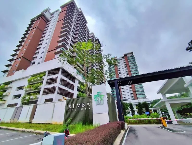 Exterior type: high-rise condominium; features: modern facade with green accents, multiple storeys, balconies on upper floors, landscaped entrance with signage, gated entry with security, surrounded by greenery, parking area visible, driveway with interlocking pavers; style: modern.