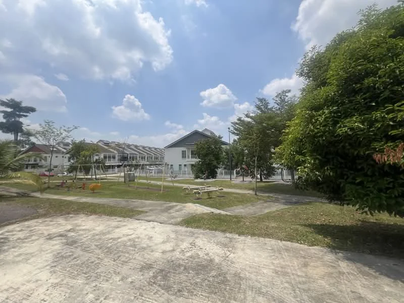 Exterior type: linked terrace house; features: manicured lawn, mature trees, playground equipment, swings, paved walkway, surrounding greenery, two-storey linked terrace houses, open space, clear blue sky; style: modern.