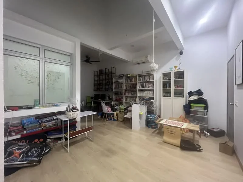 Room features: light wood flooring, white painted walls, ceiling fan, large window with frosted glass, built-in shelving unit, freestanding storage cabinets, desk with computer setup, various boxes and items on the floor; style: modern.