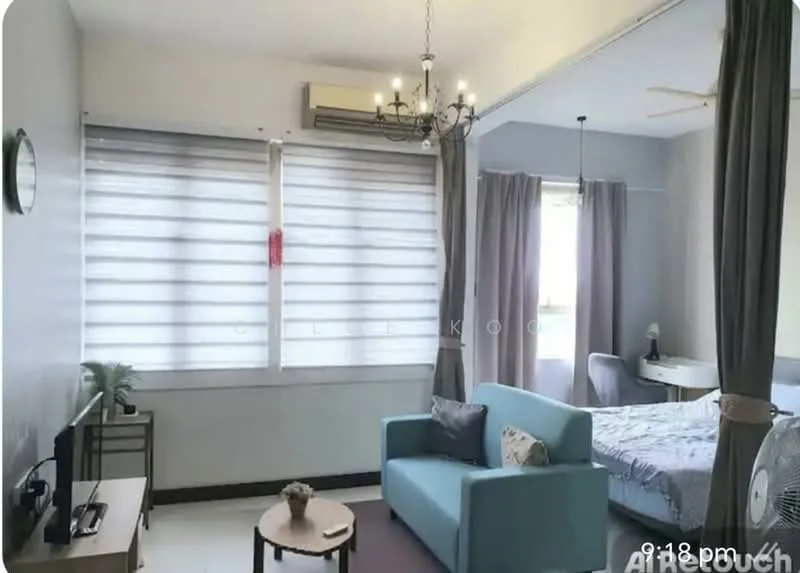 Living features: light grey painted walls, white ceiling with chandelier, floor-to-ceiling windows with sheer curtains, grey curtains, light-colored sofa, wooden TV console, wall-mounted TV, decorative plant on console, air conditioning unit, area rug, bed visible in background; style: modern.