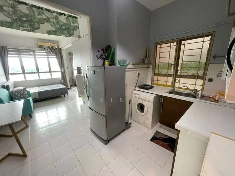 Room features: white tiled flooring, grey walls, floor-to-ceiling windows, green accent wall with floral pattern, stainless-steel fridge, washing machine, single-bowl stainless-steel sink, wood cabinetry, kitchen countertop, dining table with wooden legs, bed with grey bedding, sofa in light blue, curtains, light fixture, decorative plants; style: modern; view: city.