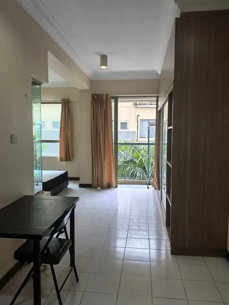 Room features: white painted walls, tile flooring, large windows, curtains, balcony access, built-in shelving unit, dining table, black chair, greenery view; style: modern; view: garden.