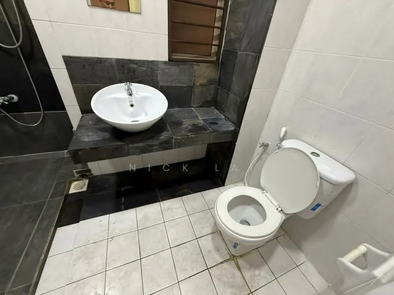 Bathroom features: white ceramic toilet, single-sink vanity with round basin, black stone countertop, shower area with wall-mounted showerhead, grey tiled walls, white tiled flooring, window with wooden slats; style: modern.