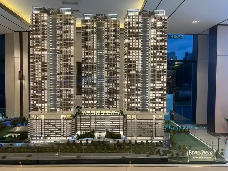 Exterior type: high-rise condominium; features: three high-rise towers, glass curtain wall, illuminated facade, landscaped garden at base, parking podium, manicured lawn, surrounding greenery, signage with 'RIVER PARK', road access in front, model display, detailed architectural model; style: modern.