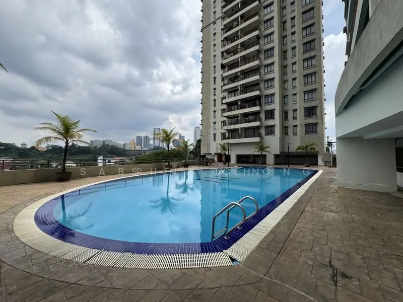 Exterior type: high-rise condominium; features: infinity pool, pool deck with loungers, surrounded by palm trees, concrete facade, glass balcony railings, city skyline view in background, approximately 20-storey high-rise; style: modern.