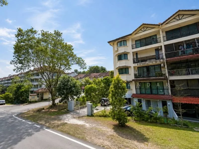 Exterior type: low-rise apartment block; features: white painted facade, balconies with railings, red tiled roof, landscaped garden area, mature trees, manicured lawn, parking area visible, surrounded by greenery; style: modern.