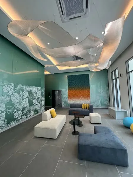 Lobby features: grey tile flooring, green glass wall, decorative wall with floral pattern, sofa with white upholstery and yellow cushions, blue sectional sofa, black coffee table, decorative wall with gradient color, ceiling with integrated LED lighting, exposed air conditioning unit, hanging decorative elements; style: modern.