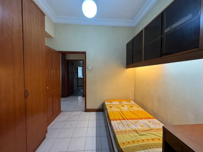 Bedroom features: single bed with patterned bedding, built-in wardrobe with wooden doors, wooden desk, white tiled flooring, yellow painted walls, ceiling light fixture, crown moulding, window with view to hallway; style: traditional.