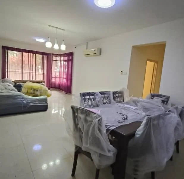 Living features: sofa covered with plastic, dining table with plastic cover, 4 dining chairs, 2 ceiling lights, wall-mounted split AC, large windows with sheer curtains, white painted walls, glossy tile flooring; style: modern; view: garden.