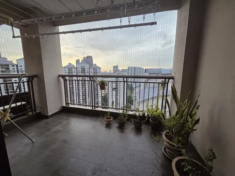 Balcony features: sliding glass door, railing with metal frame, floor-to-ceiling windows, grey tiled flooring, potted plants, hanging plants, city skyline view, overhead lighting, clothes drying rack; style: modern; view: city.