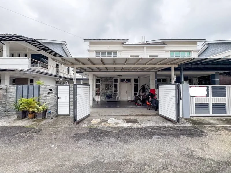 Exterior type: linked terrace house; features: white painted facade, stone cladding at entrance, flat roof, double-volume car porch with awning, manicured lawn, paved driveway, security gate, surrounded by mature greenery; style: modern.