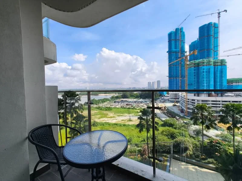 Balcony features: glass railing, round glass-top table, black wicker chairs, tiled flooring, view of construction site, view of greenery, view of water, overcast sky; view: city.