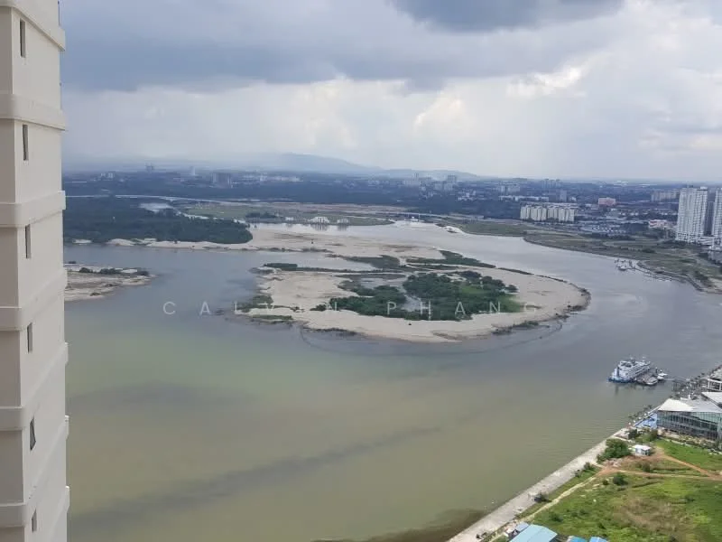 Exterior features: river view, landscape with sandbanks, urban skyline in background, cloudy sky, greenery along riverbank.