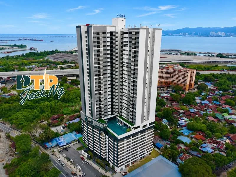 Exterior type: high-rise condominium; features: white painted facade, glass curtain wall, recessed balconies, approximately 20-storey high-rise, surrounded by mature greenery, views of the sea, adjacent to highway, parking lot visible, landscaped garden at base; style: modern.