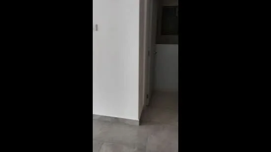 Room features: white painted walls, grey tile flooring, doorway leading to another room, neutral color scheme, minimalist design; style: modern.