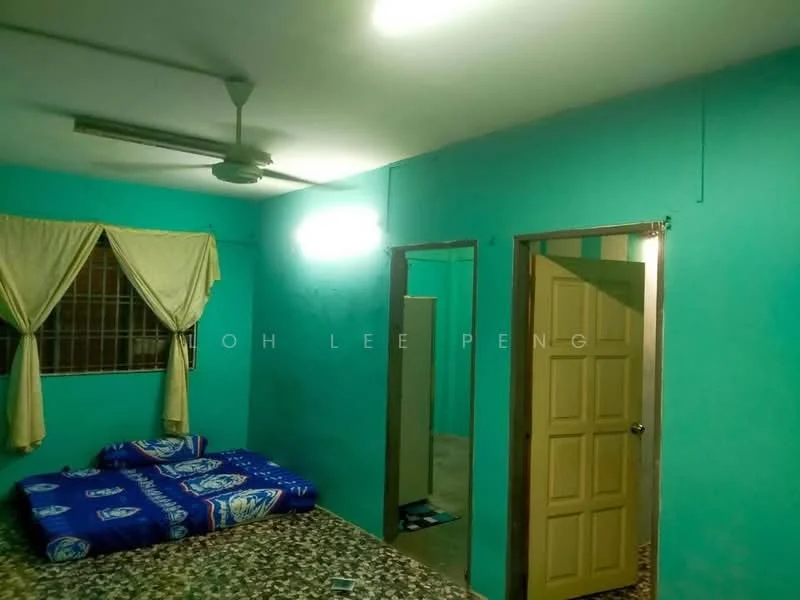 Room features: turquoise painted walls, ceiling fan, window with metal grille, light fixture on ceiling, door with panel design, flooring with patterned tiles, curtains in light fabric, mattress on the floor with blue cover.