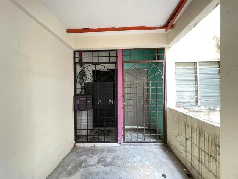 Room features: concrete flooring, white painted walls, metal security grilles, green accent wall, pink accent wall, window with metal grilles, exposed ceiling, natural light from window.