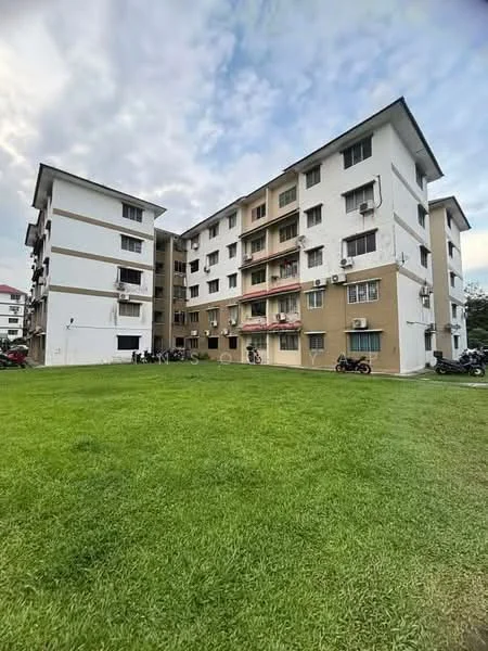 Exterior type: low-rise apartment block; features: white painted facade, brown accent facade, multiple storeys, balconies on upper floors, ground-level green lawn, visible air conditioning units, parking area for motorcycles, surrounding greenery; style: modern.