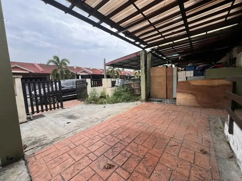 Exterior type: linked terrace house; features: paved driveway, covered car porch, brick-patterned flooring, wooden fence, metal gate, surrounding greenery, adjacent houses visible, partially enclosed area; style: modern.