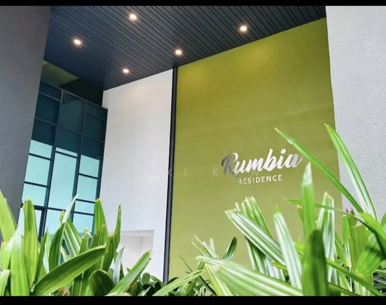 Exterior features: green accent wall, glass windows, modern architectural design, landscaped greenery in foreground, recessed lighting, signage with 'Rumbia Residence', white painted facade, dark ceiling; style: modern.