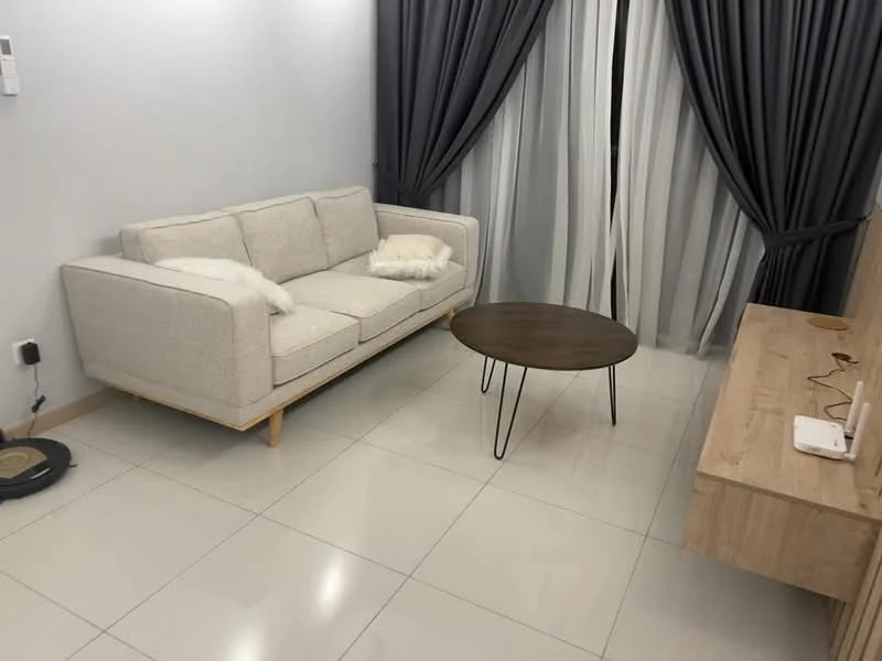 Living features: light grey fabric sofa, wooden legs on sofa, round wooden coffee table with black legs, white walls, glossy white tile flooring, floor-to-ceiling windows with sheer curtains, dark grey curtains, wooden console table, wall-mounted electrical outlet, decorative throw pillows; style: modern.