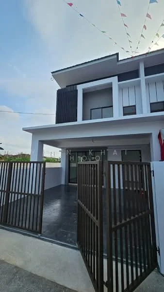 Exterior type: linked terrace house; features: white painted facade, black vertical slats, flat roof, double-storey, manicured lawn, paved walkway, fence with gate, decorative bunting, large glass doors, windows with black frames; style: modern.