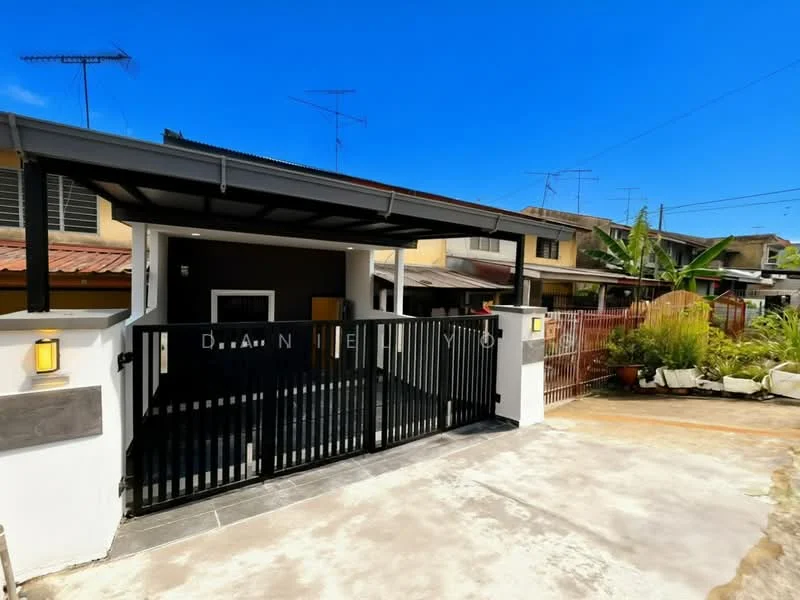 Exterior type: linked terrace house; features: black metal gate, covered car porch, white painted facade, red tiled roof, concrete driveway, landscaped garden with plants, visible antennae on rooftops, fenced perimeter, outdoor lighting fixtures; style: modern.