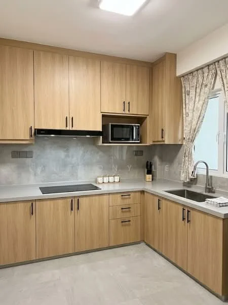 Kitchen features: light wood cabinetry, grey countertop, stainless-steel sink, chrome pull-down faucet, built-in microwave, stainless-steel range hood, ceramic tile backsplash, window with sheer curtains, grey tile flooring, black cooktop, decorative canisters on countertop; style: modern.
