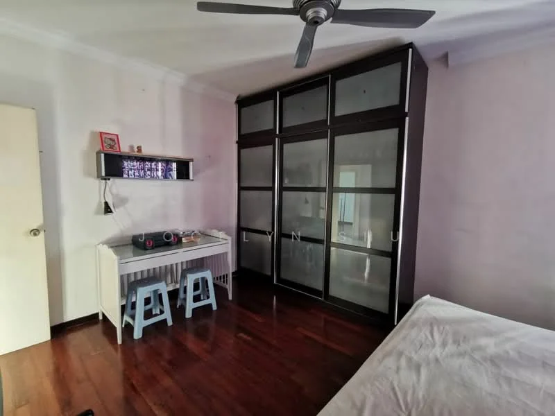 Bedroom features: wooden flooring, white painted walls, ceiling fan, built-in wardrobe with glass doors, study desk, two blue stools, decorative wall shelf, natural light from window; style: modern.