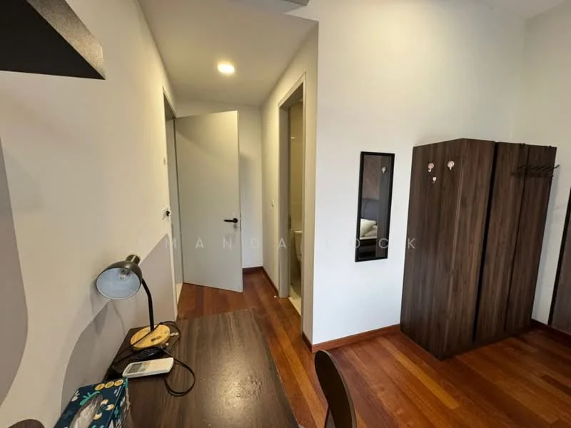 Room features: wooden flooring, white painted walls, doorway leading to another room, built-in wardrobe with dark wood finish, desk with lamp, small decorative items on desk, mirror on wall, light fixture on ceiling; style: modern.