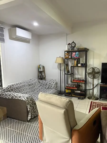 Living features: grey fabric sofa with patterned throw, beige armchair, black and white patterned area rug, wall-mounted split AC, floor lamp, bookshelf with decorative items, TV console with television, standing fan, white painted walls, tile flooring; style: modern.