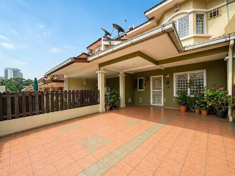 Exterior type: semi-detached house; features: terracotta tile flooring, covered porch area, green painted walls, white columns, wooden fence, potted plants, satellite dish on roof, outdoor seating area, manicured landscaping, clear blue sky; style: modern.