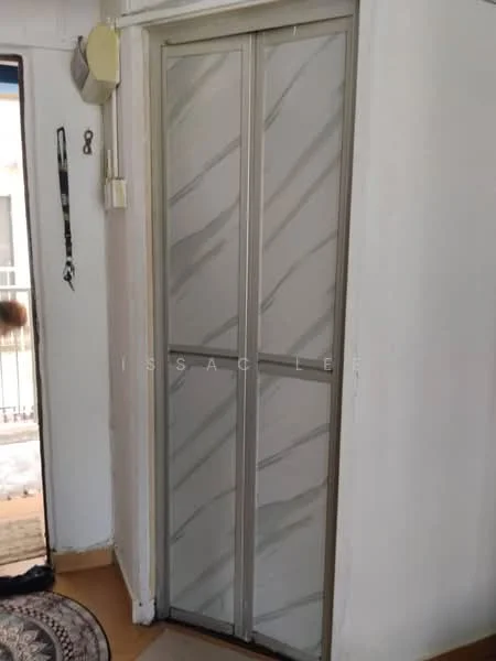 Room features: sliding door with decorative pattern, white walls, tan flooring, round area rug, door frame with metallic finish.