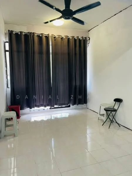 Living features: white painted walls, glossy tile flooring, 5-blade ceiling fan, large windows with sheer curtains, blackout curtains, two plastic stools, folding chair, overhead light fixture.