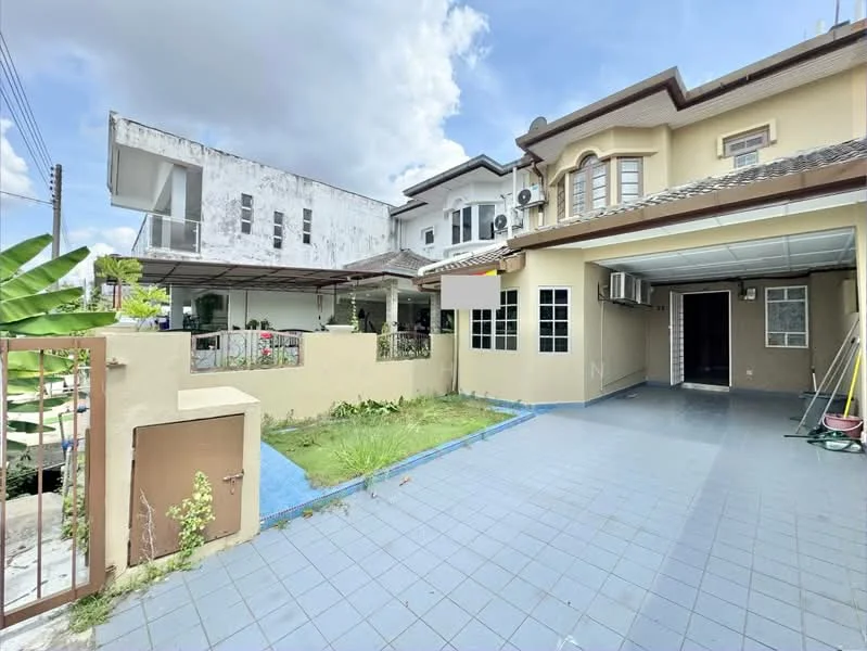 Exterior type: semi-detached house; features: paved driveway, manicured lawn, garden area, covered car porch, exterior wall with cream paint, windows with grilles, air conditioning units visible, blue tiled flooring, adjacent building with white painted facade, outdoor space with plants; style: modern.