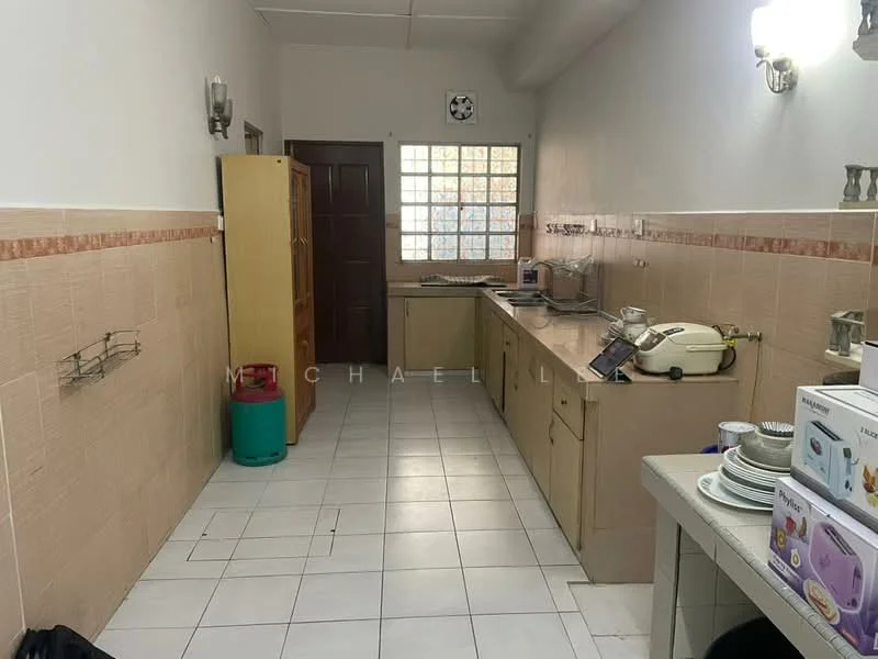Kitchen features: L-shaped countertop, cream-colored laminate countertop, white tiled backsplash, built-in cabinets with wooden finish, single-bowl sink, chrome faucet, freestanding stove, microwave, refrigerator, ceramic tile flooring, wall-mounted light fixtures, window with grid pattern, open shelving, kitchen utensils on countertop.