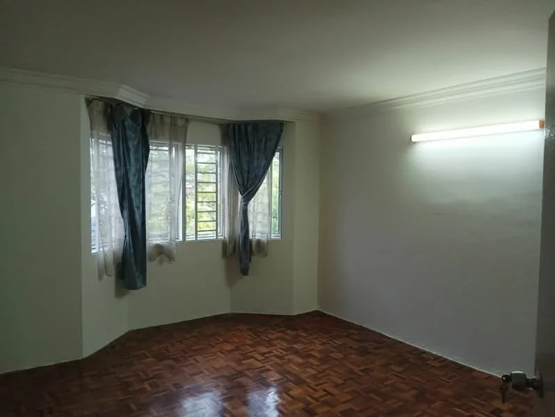 Room features: white painted walls, parquet wood flooring, curtains in blue and sheer, corner windows, ceiling with crown moulding, fluorescent light fixture.
