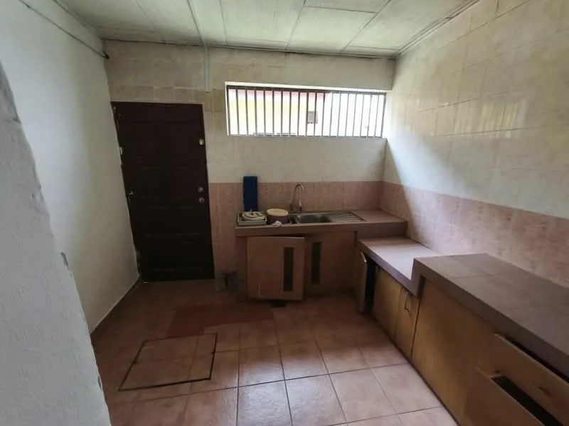 Kitchen features: single-bowl stainless-steel sink, chrome faucet, laminate countertop, wood cabinetry, tile backsplash, ceramic tile flooring, window with horizontal bars, gas stove, kitchen cabinet with countertop, door leading outside.