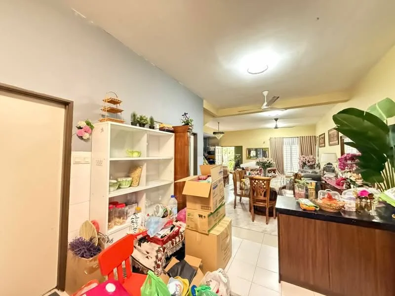 Room features: white walls, light grey accent wall, tile flooring, ceiling fan, wooden dining table, wooden dining chairs, open shelving unit, boxes and packing materials, decorative plants, various kitchenware, refrigerator, sofa, curtains, light fixture; style: modern.