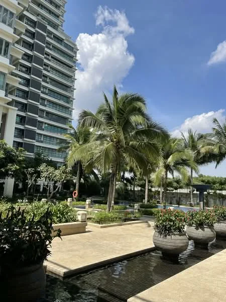 Exterior type: high-rise condominium; features: tropical landscaping, palm trees, manicured lawn, stone-paved walkway, water feature, swimming pool, outdoor seating area, lush greenery; style: modern.