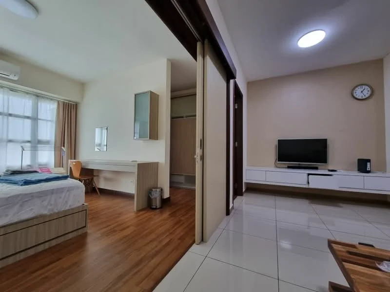 Bedroom features: queen-size bed with white bedding, wooden headboard, study desk with mirror, wooden chair, built-in wardrobe, floor-to-ceiling window with sheer curtains, wall-mounted TV, wooden flooring, 1 wall-mounted split AC, recessed ceiling light; style: modern. Living features: TV console with storage, wall-mounted TV, light-colored wall, clock on wall, tile flooring; style: modern.