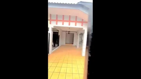 Room features: tiled flooring in yellow, white walls, ceiling with decorative beams, hanging light fixture, open layout, large windows, doorway leading to another room, covered porch area; style: modern.