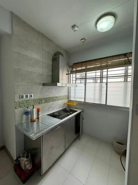 Kitchen features: stainless-steel countertop, stainless-steel cabinets, built-in gas hob, extraction hood, white tiled backsplash with green mosaic accents, single-bowl stainless-steel sink, window with blinds, recessed ceiling lights, light-colored tiled flooring; style: modern.