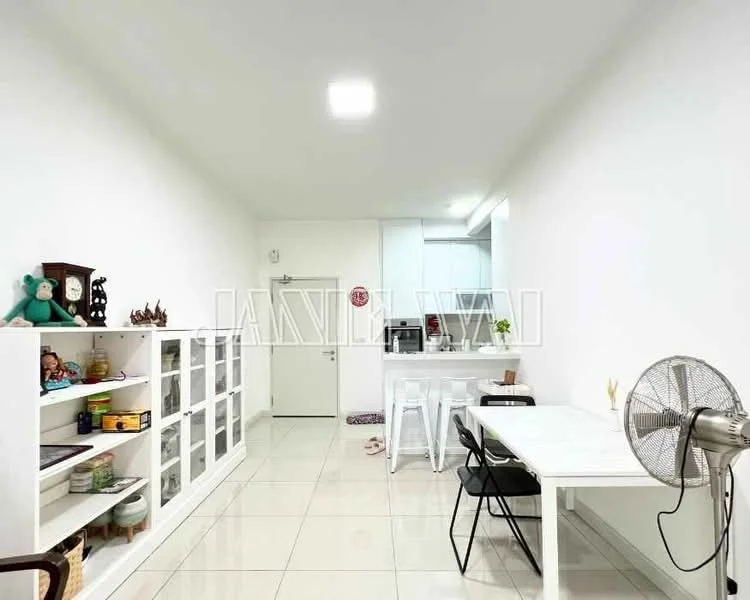 Dining features: white painted walls, glossy tile flooring, white ceiling, recessed downlights, dining table, black chairs, open shelving unit, decorative items on shelves, kitchen area visible in background, fan, door leading to hallway; style: modern.